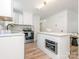 Bright kitchen featuring white cabinets, a stainless steel oven, and a center island at 1831 Erie St, Charlotte, NC 28216