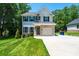 Charming two-story home features a well-manicured lawn, brick accents, and an attached two-car garage, perfect for Gathering living at 2045 13Th Ne St # 3, Hickory, NC 28601