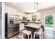 Bright kitchen with stainless steel appliances, an island with seating, and a sliding glass door leading to the backyard at 2045 13Th Ne St # 3, Hickory, NC 28601