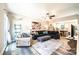 Inviting living room featuring an open layout, wood-look floors, a large sectional sofa and a view of the kitchen at 2045 13Th Ne St # 3, Hickory, NC 28601
