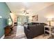 Bright living room with hardwood floors, a ceiling fan, a large sofa, and a view of the front porch, offering comfort and style at 2045 13Th Ne St # 3, Hickory, NC 28601