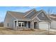 Stylish home showcasing modern architectural details, a covered porch, and manicured landscaping at 21011 Timber Tide Aly # 184, Lancaster, SC 29720