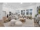 Spacious living room filled with neutral furniture, large windows, and access to the kitchen area at 21011 Timber Tide Aly # 184, Lancaster, SC 29720