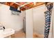 Unfinished basement featuring a sink, water heater, concrete block shower, and exposed ceiling at 215 Jan Mar Dr, China Grove, NC 28023