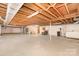 Unfinished basement with exposed beams, fireplace, and utility area at 215 Jan Mar Dr, China Grove, NC 28023