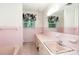 Vintage-style pink bathroom featuring tiled walls, a built-in vanity, and natural lighting at 215 Jan Mar Dr, China Grove, NC 28023