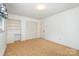 Bedroom with plush carpet, window, built-in desk, and closet at 215 Jan Mar Dr, China Grove, NC 28023