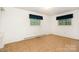 Sunlit bedroom featuring plush carpet, two windows and neutral wall color at 215 Jan Mar Dr, China Grove, NC 28023