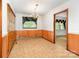 Traditional dining room featuring wood paneling, a chandelier, and a built-in display cabinet at 215 Jan Mar Dr, China Grove, NC 28023