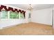 Dining room with large window and traditional chandelier at 215 Jan Mar Dr, China Grove, NC 28023