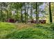Exterior view of the brick home on a lot with mature trees and foliage at 215 Jan Mar Dr, China Grove, NC 28023