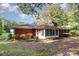 Charming brick home with a screened-in porch and mature landscaping at 215 Jan Mar Dr, China Grove, NC 28023