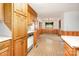 View from the kitchen showing wooden cabinets and a view into the dining room at 215 Jan Mar Dr, China Grove, NC 28023