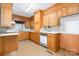 Traditional kitchen with oak cabinets, lots of storage, and a clean white countertop at 215 Jan Mar Dr, China Grove, NC 28023