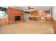 Cozy living room featuring a brick fireplace, and views into the connected kitchen and sunroom at 215 Jan Mar Dr, China Grove, NC 28023