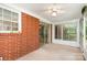 Enclosed sunroom featuring brick wall and sliding glass door at 215 Jan Mar Dr, China Grove, NC 28023
