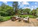 Spacious backyard featuring patio furniture, a fire pit, and lush greenery at 227 Wingrave Dr, Charlotte, NC 28270