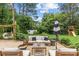 Backyard patio with comfortable seating, shade, and landscaping at 227 Wingrave Dr, Charlotte, NC 28270