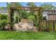 Inviting backyard featuring a swing set arbor and outdoor seating for relaxing and entertaining at 227 Wingrave Dr, Charlotte, NC 28270
