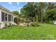 Beautifully landscaped backyard with patio, lounge area, and lush greenery ideal for outdoor living at 227 Wingrave Dr, Charlotte, NC 28270