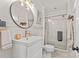 Bright bathroom with a stylish vanity, a modern round mirror, and a glass-enclosed shower at 227 Wingrave Dr, Charlotte, NC 28270