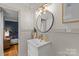 Bright bathroom with a modern vanity, round mirror, and neutral decor at 227 Wingrave Dr, Charlotte, NC 28270