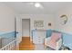 Charming Bedroom with two-tone walls, a changing table, and a comfortable rocking chair at 227 Wingrave Dr, Charlotte, NC 28270