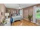 Cozy bedroom with hardwood floors, natural light, and a dedicated workspace at 227 Wingrave Dr, Charlotte, NC 28270