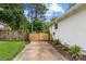Driveway with wooden gate with landscaped yard and a white home at 227 Wingrave Dr, Charlotte, NC 28270
