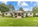 Charming ranch-style home with a manicured lawn, lush landscaping and inviting front porch swings at 227 Wingrave Dr, Charlotte, NC 28270
