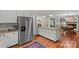 Open kitchen with granite counters, stainless steel appliances, view into dining room and living room area at 227 Wingrave Dr, Charlotte, NC 28270