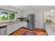 Bright kitchen featuring granite countertops, stainless steel appliances, and a view of the lush backyard at 227 Wingrave Dr, Charlotte, NC 28270