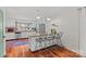 Well-lit kitchen with granite countertops, stainless appliances, a breakfast bar with seating, and hardwood floors at 227 Wingrave Dr, Charlotte, NC 28270