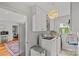 Bright laundry room with modern washer/dryer, storage cabinets, and a view into the kitchen at 227 Wingrave Dr, Charlotte, NC 28270