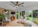Bright sunroom with brick walls, ample windows, and a ceiling fan at 227 Wingrave Dr, Charlotte, NC 28270