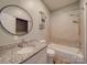 Bathroom with granite vanity, round mirror, shower-tub combo, and vinyl flooring at 2440 Myers St, Gastonia, NC 28056