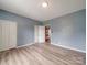 Spacious bedroom with light blue walls, vinyl flooring, and closet for ample storage at 2440 Myers St, Gastonia, NC 28056