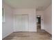 Well-lit bedroom boasts white walls, vinyl flooring, and closet for ample storage at 2440 Myers St, Gastonia, NC 28056