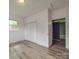 Bedroom boasts light pink walls, vinyl flooring, and closet for ample storage at 2440 Myers St, Gastonia, NC 28056