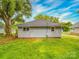 Rear view of cozy home with green yard, showing its simple design and windows at 2440 Myers St, Gastonia, NC 28056
