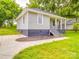 View of the exterior of a home with gray siding, a covered front porch, and a curved driveway at 2440 Myers St, Gastonia, NC 28056