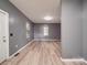Open living area with sleek flooring, neutral gray walls, and multiple windows providing natural light at 2440 Myers St, Gastonia, NC 28056