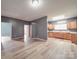 Spacious living room with light wood flooring, neutral gray walls, and an open layout to the kitchen at 2440 Myers St, Gastonia, NC 28056