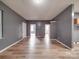 Bright living room featuring modern flooring, neutral walls, and multiple doorways for easy flow at 2440 Myers St, Gastonia, NC 28056