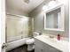 Bathroom with a combination shower and tub, plus a white vanity and cabinet with gray walls at 2619 Quailrush Rd, Charlotte, NC 28226