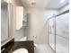 Well-lit bathroom featuring a granite countertop, neutral paint, and a glass door shower at 2619 Quailrush Rd, Charlotte, NC 28226