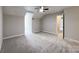 Carpeted bedroom features vaulted ceilings, a ceiling fan, neutral paint, and an open doorway to another room at 2619 Quailrush Rd, Charlotte, NC 28226