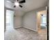 Bedroom with a ceiling fan, soft carpet, neutral paint, and a view of the outdoors from the window at 2619 Quailrush Rd, Charlotte, NC 28226