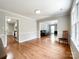 Dining room with hardwood floors, neutral paint, and an open layout to the living room and kitchen at 2619 Quailrush Rd, Charlotte, NC 28226