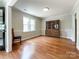 Dining room with gleaming hardwood floors, a classic china cabinet, and abundant natural light at 2619 Quailrush Rd, Charlotte, NC 28226